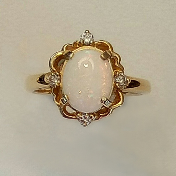 9 x 7 Oval shaped Opal set in a fancy ring with 0.06 diamonds.